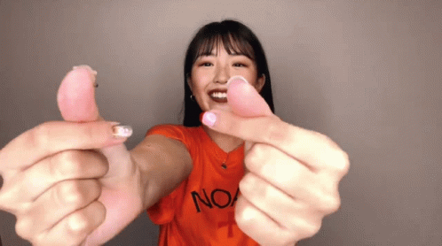 A Woman Wearing An Orange T-Shirt With The Word No On It GIF