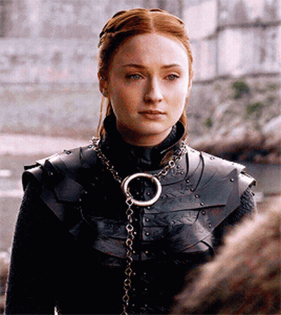 A Woman Wearing Armor And A Necklace With A Ring On It GIF
