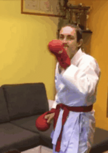 A Woman Wearing Boxing Gloves And A White Kimono GIF