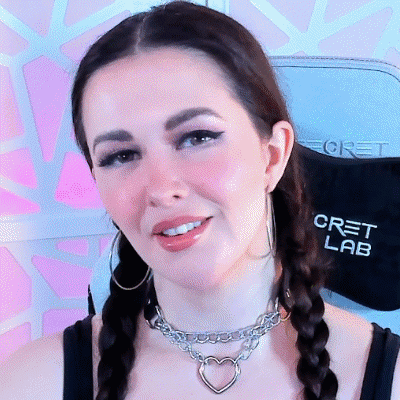 A Woman Wearing Braids And A Necklace With A Heart Shaped Charm GIF