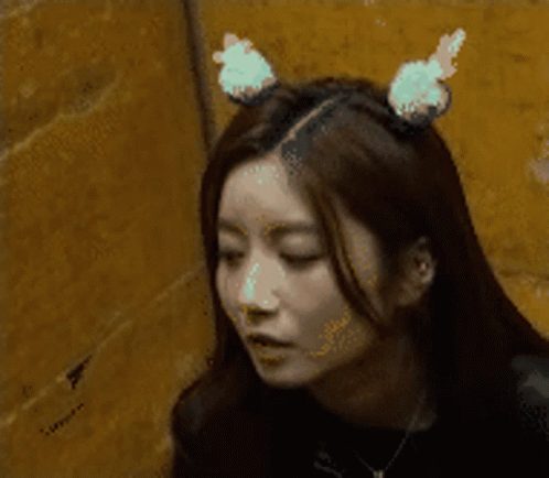 A Woman Wearing Bunny Ears On Her Head GIF