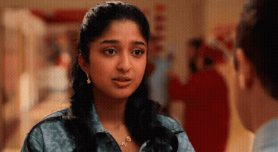 A Woman Wearing Earrings Looks At A Man GIF