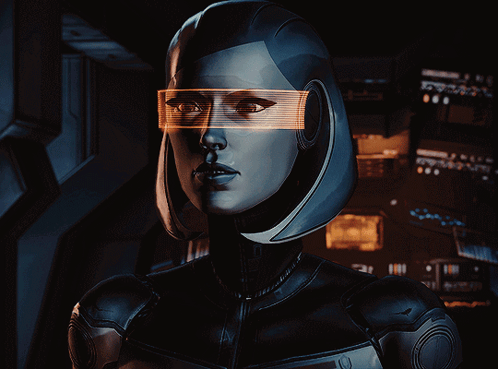 A Woman Wearing Futuristic Glasses Looks At The Camera With A Dark Background GIF