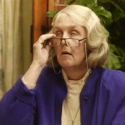 A Woman Wearing Glasses And A Blue Jacket GIF