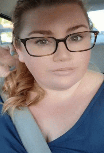 A Woman Wearing Glasses And A Blue Shirt GIF