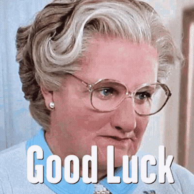 A Woman Wearing Glasses And A Blue Shirt Has The Words Good Luck On Her Face GIF