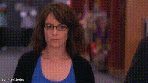 A Woman Wearing Glasses And A Blue Shirt Is Asking What A Week Huh ? GIF
