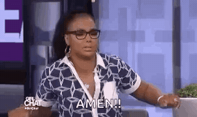A Woman Wearing Glasses And A Blue Shirt Is Sitting On A Couch . GIF