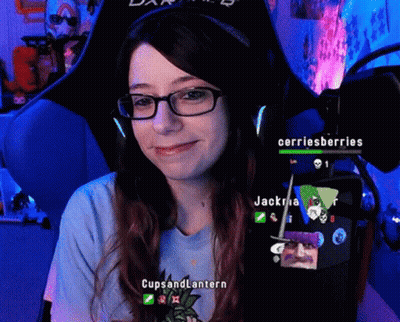 A Woman Wearing Glasses And A Blue Shirt That Says Cups And Lantern Is Smiling GIF