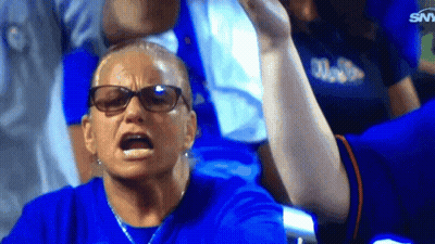 A Woman Wearing Glasses And A Blue Shirt With The Word Miami On It Looks Angry GIF