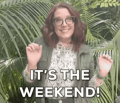 A Woman Wearing Glasses And A Green Jacket Is Standing In Front Of Palm Trees And Says `` It 'S The Weekend '' . GIF