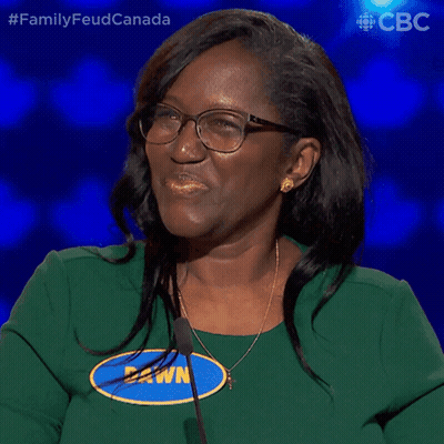 A Woman Wearing Glasses And A Green Shirt Says " Yes " GIF