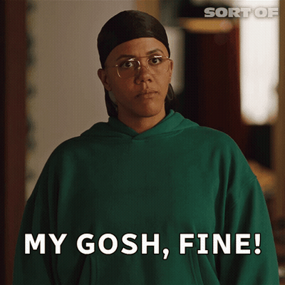A Woman Wearing Glasses And A Green Sweatshirt Says My Gosh Fine GIF
