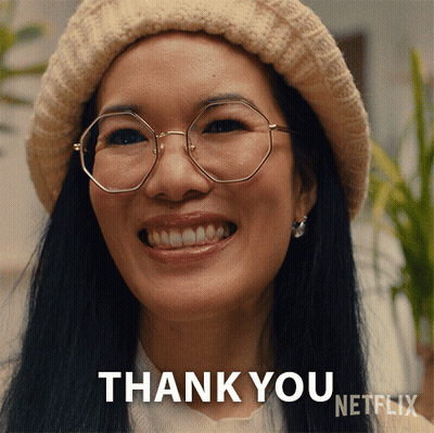A Woman Wearing Glasses And A Hat Is Smiling And Says Thank You GIF