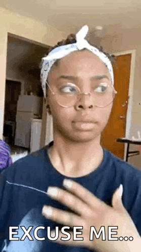 A Woman Wearing Glasses And A Headband Is Making A Funny Face And Saying `` Excuse Me '' . GIF