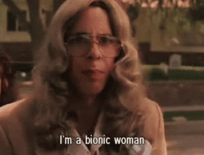 A Woman Wearing Glasses And A Jacket Is Talking About Herself . GIF