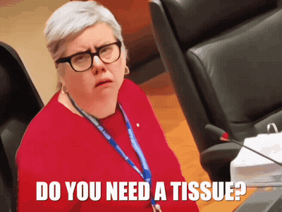 A Woman Wearing Glasses And A Lanyard With The Words Do You Need A Tissue GIF
