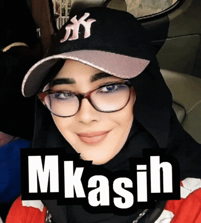 A Woman Wearing Glasses And A Ny Hat With The Word Mkasih On It GIF