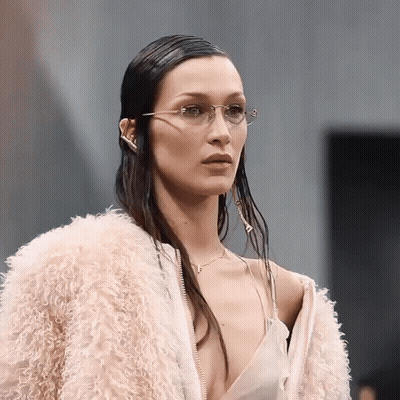 A Woman Wearing Glasses And A Pink Fur Coat GIF