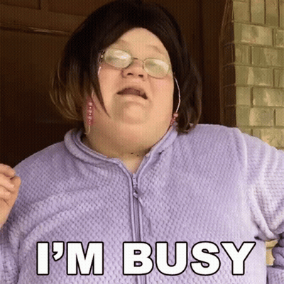 A Woman Wearing Glasses And A Purple Sweater Says I 'M Busy GIF