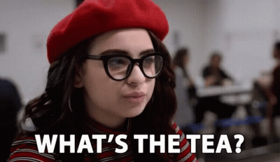 A Woman Wearing Glasses And A Red Beret Is Asking What 'S The Tea GIF