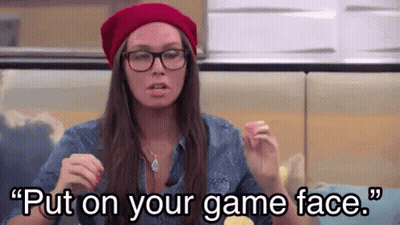 A Woman Wearing Glasses And A Red Hat Is Saying " Put On Your Game Face " . GIF