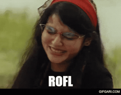 A Woman Wearing Glasses And A Red Headband Is Smiling And The Word Rofl Is Written On The Screen . GIF