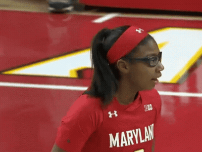 A Woman Wearing Glasses And A Red Maryland Shirt GIF