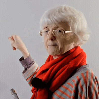 A Woman Wearing Glasses And A Red Scarf Holds A Bottle Of Glue GIF