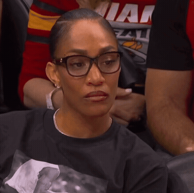 A Woman Wearing Glasses And A Shirt That Says Miami GIF