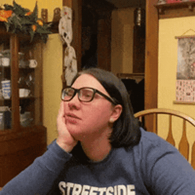 A Woman Wearing Glasses And A Streetside Sweatshirt GIF