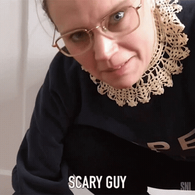 A Woman Wearing Glasses And A Sweater With The Word Scary Guy On It GIF