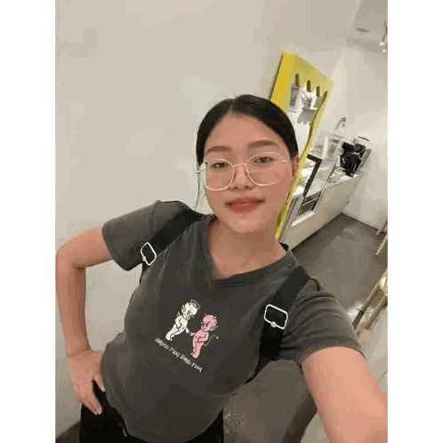 A Woman Wearing Glasses And A T-Shirt That Says Angels And Demons Sticker