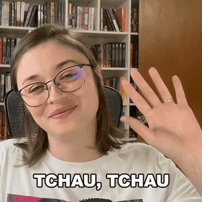 A Woman Wearing Glasses And A Tchau Tchau Shirt GIF