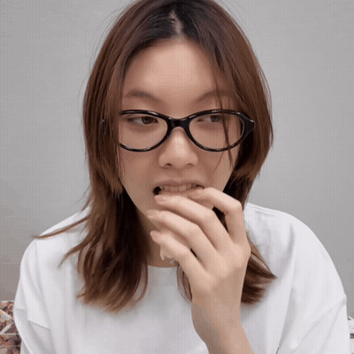 A Woman Wearing Glasses And A White Shirt GIF