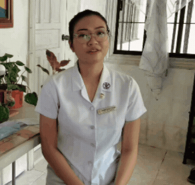 a woman wearing glasses and a white shirt with a name tag that says ' nurse ' on it