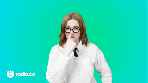 A Woman Wearing Glasses And A White Sweater Is Standing With Her Hands On Her Hips GIF