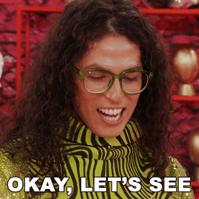 A Woman Wearing Glasses And A Zebra Print Sweater Says " Okay Let 'S See " GIF