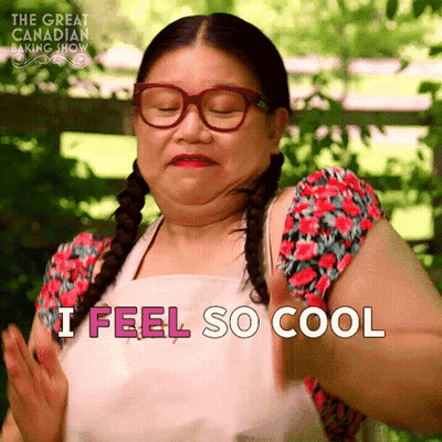 A Woman Wearing Glasses And An Apron Is Saying I Feel So Cool GIF