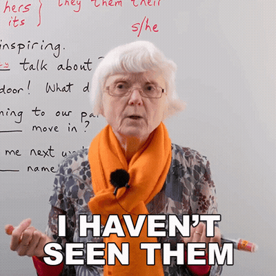 A Woman Wearing Glasses And An Orange Scarf Is Standing In Front Of A White Board And Says I Haven 'T Seen Them GIF