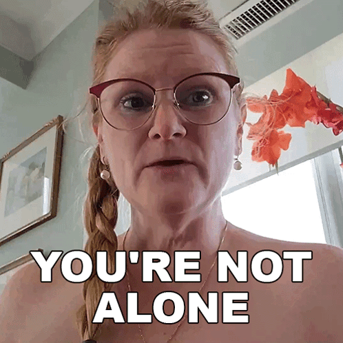 A Woman Wearing Glasses And Earrings Says You 'Re Not Alone GIF
