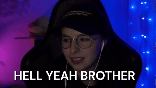 A Woman Wearing Glasses And Headphones Is Smiling In Front Of A Blue Background And The Words `` Hell Yeah Brother '' . GIF