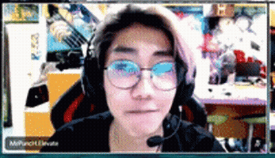A Woman Wearing Glasses And Headphones Looks At The Camera GIF
