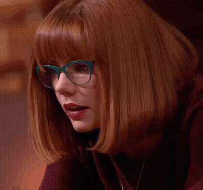A Woman Wearing Glasses And Red Lipstick Says Le Gasp . GIF