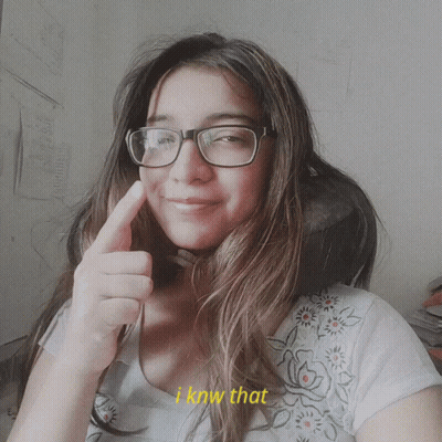A Woman Wearing Glasses Giving A Thumbs Up With The Words I Know That Behind Her GIF