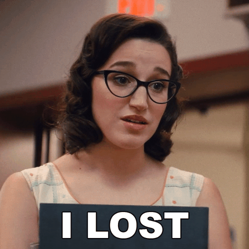 A Woman Wearing Glasses Holds A Sign That Says I Lost GIF