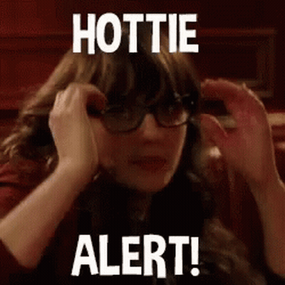 A Woman Wearing Glasses Is Covering Her Ears With Her Hands And The Words `` Hottie Alert ! '' GIF