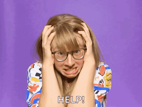 A Woman Wearing Glasses Is Holding Her Head And Screaming For Help GIF