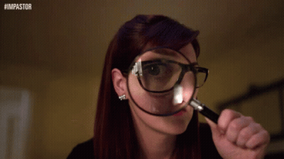 A Woman Wearing Glasses Is Looking Through A Magnifying Glass With The Hashtag #Impastor On The Bottom GIF