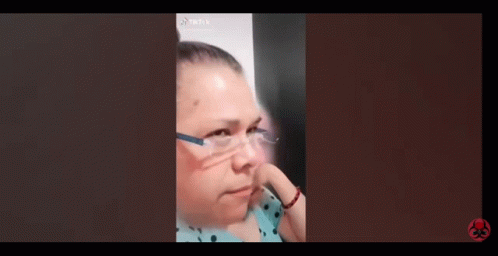 A Woman Wearing Glasses Is Making A Funny Face In A Tiktok Video . GIF